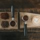 coffee beans beside coffee powder on brown wooden board