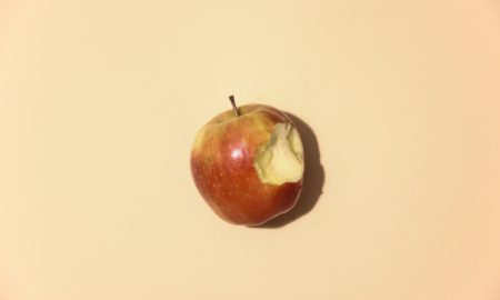 red apple fruit on white table