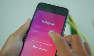 a person holding a cell phone with the amazon app on the screen