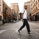 man in white long sleeve shirt and black pants standing on road during daytime