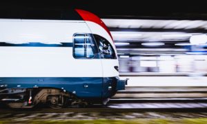 blue and white train on rail tracks