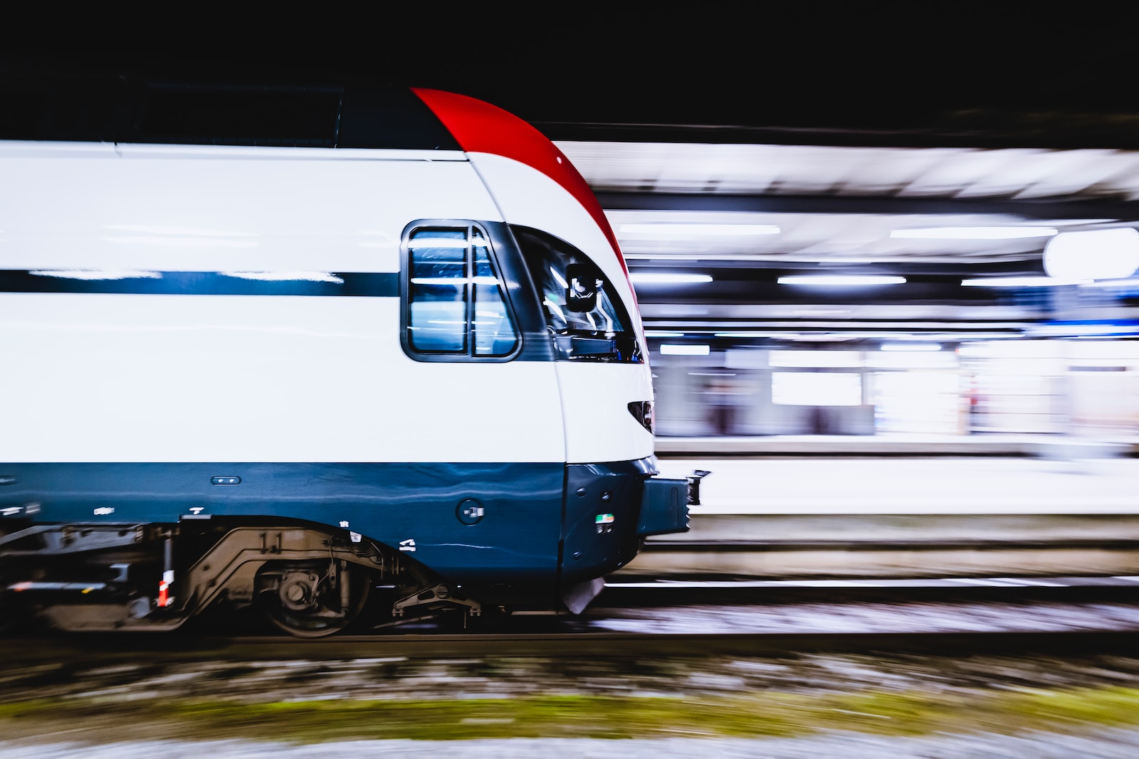 blue and white train on rail tracks