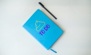 a notebook with a pen on top of it