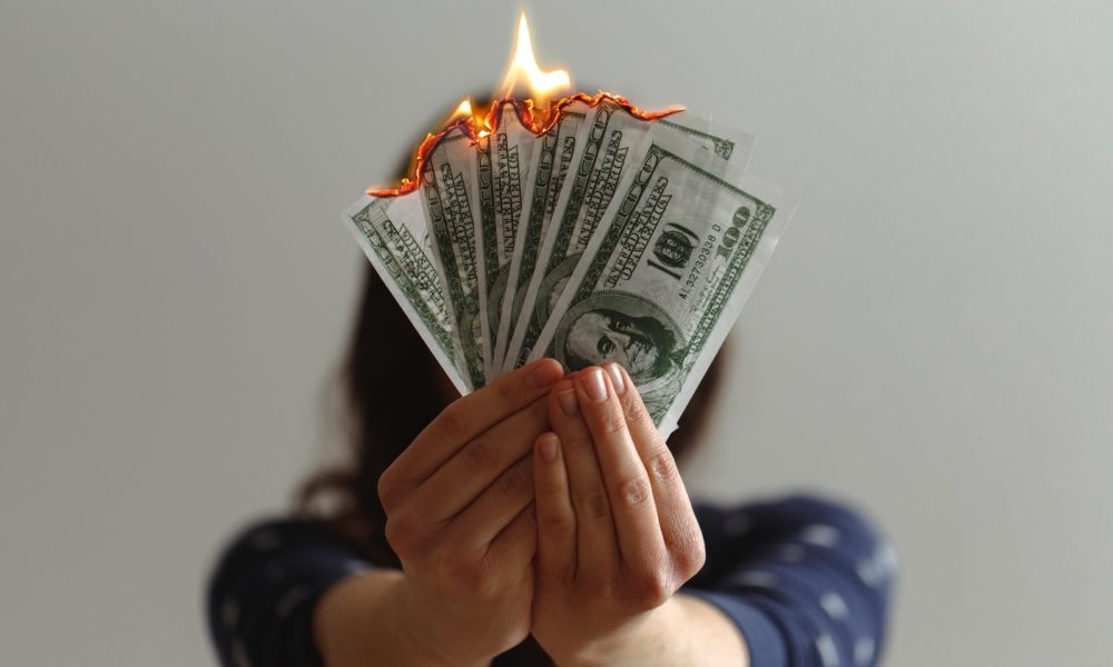 a fan of fake American dollars on fire