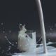 white candle in clear glass holder